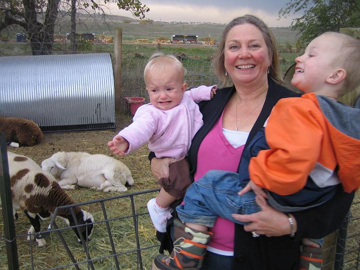 IMG_3410.JPG - Grandma and Hunter are trying to get Natalie to smile, but she just wants her Pop-pop