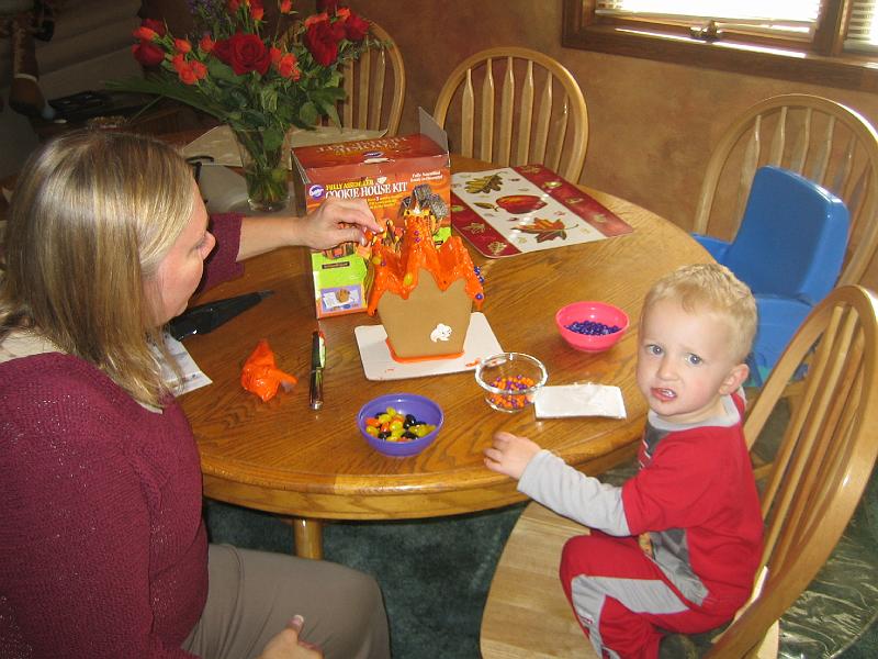 IMG_2605.JPG - Grandma and Hunter making a candy house